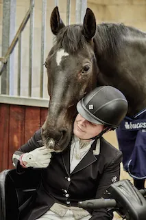 Amanda's horse nuzzling her in the stable