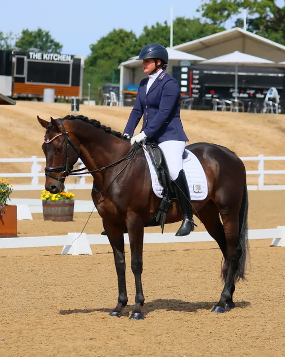 Amanda on Kirkstall Spirit, a bay gelding, at halt in the outdoor arena at Hartpury