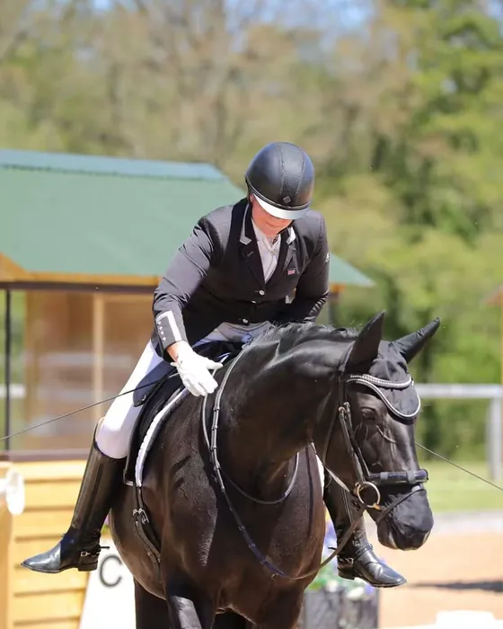 Amanda giving New Princess, a black mare, a pat after her test