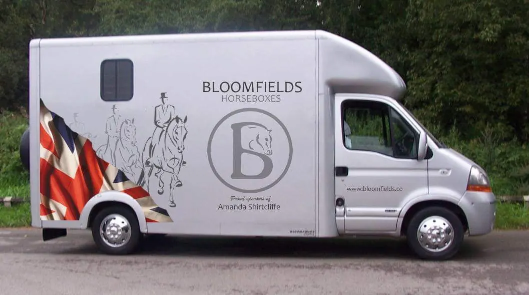 Silver Bloomfields horsebox with a Union Flag and dressage riders on the side, lettered Proud sponsors of Amanda Shirtcliffe