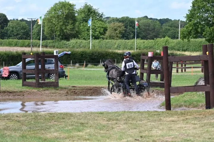 Amanda driving Ranger through a water splash on a marathon course