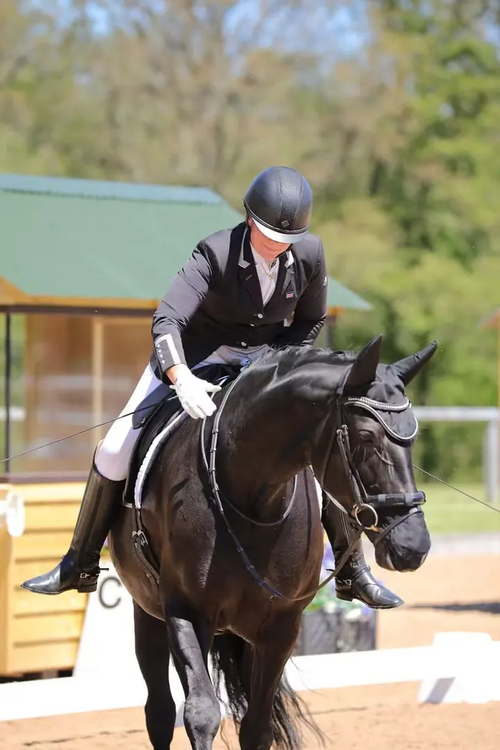 Amanda giving the black mare New Princess a pat after her test