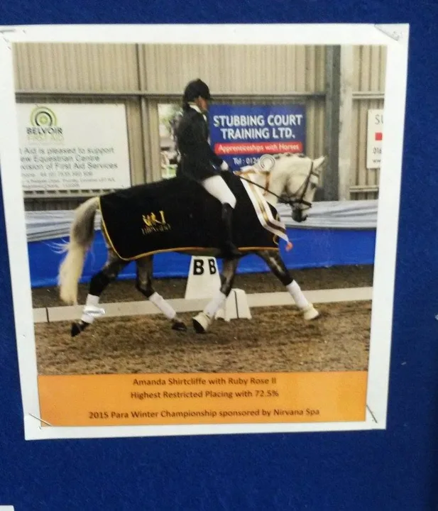 Amanda riding the grey mare Ruby Rose II in a champion’s rug at the Para Winter Championships
