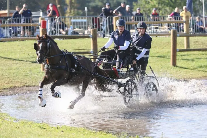Amanda and her back-stepper Charlie Parker King in Racesafe body protectors with personalised covers, driving Ranger through the water at the 2025 World Championships